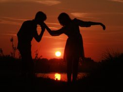 love-couple-kissing-on-hand-at-sunset