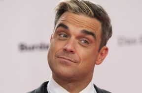 Robbie Williams arrives for the Bambi 2013 media awards in Berlin, Germany, Thursday, Nov. 14, 2013. (AP Photo/Gero Breloer)