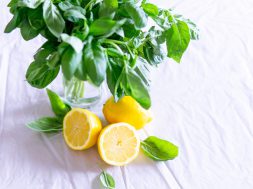 sliced-lemon-and-basil-leaves-on-glass-1585849