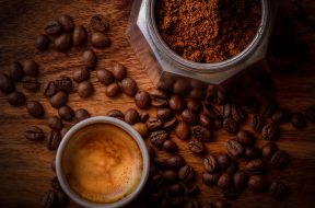 white-ceramic-mug-filled-with-coffee-beside-coffee-beans-678654