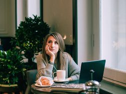 woman-in-gray-sweater-sitting-on-chair-in-front-of-laptop-3681622