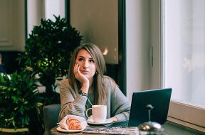 woman-in-gray-sweater-sitting-on-chair-in-front-of-laptop-3681622