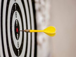 shallow depth of field shot of darts in bullseye on dartboard