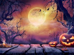 Jack O' Lantern With Candles In Violet Landscape With Full Moon