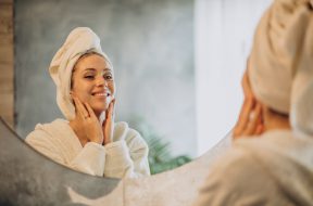 Woman at home applying cream mask